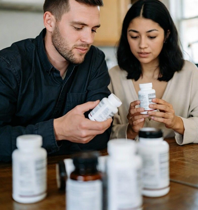 parents reading supplement labels at a kitchen table